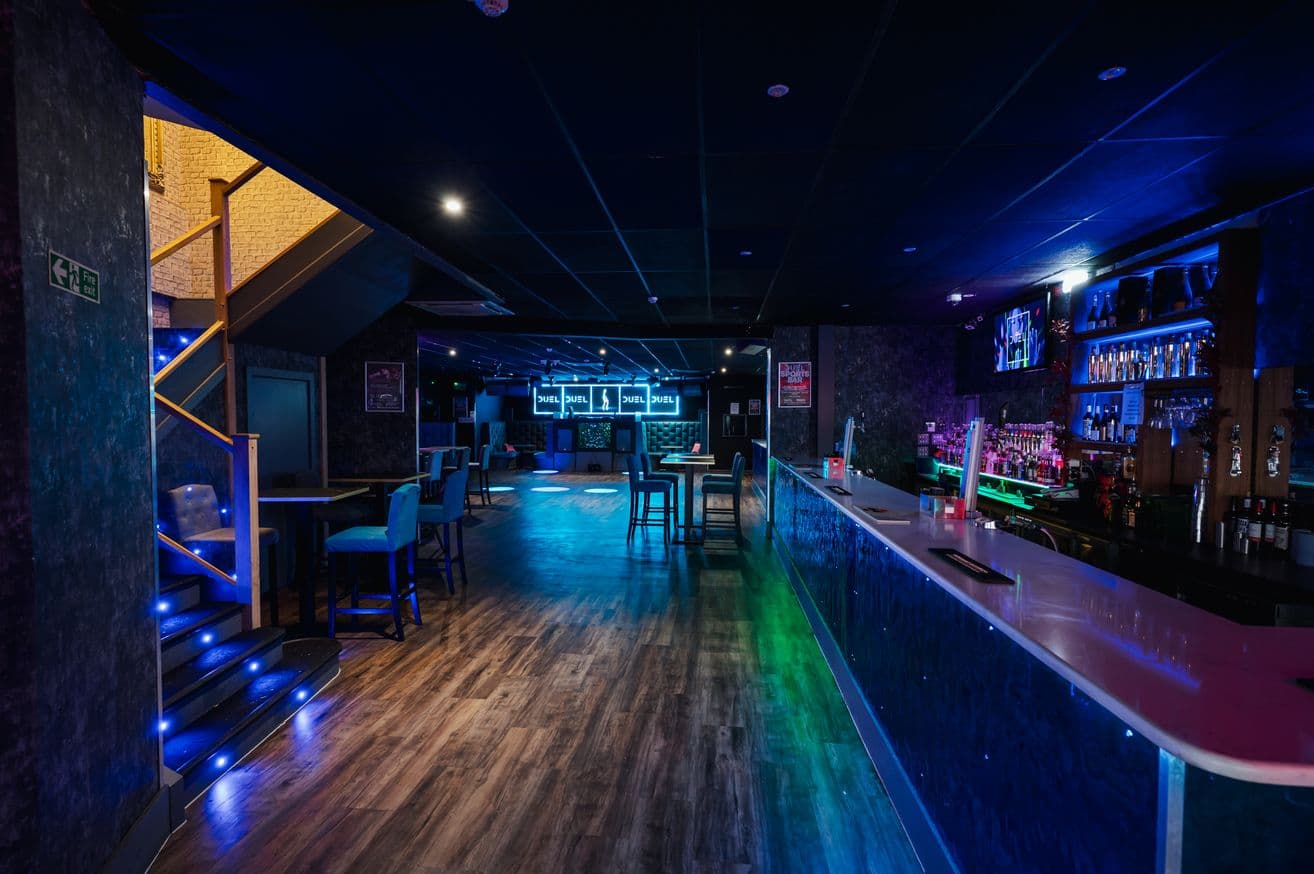 The Main Room at DUEL, its long bar running down to the dance floor
